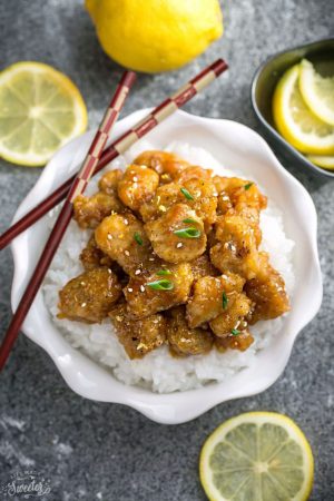 Asian Lemon Chicken -a delicious homemade Chinese Lemon Chicken takeout. Coated in a refreshingly sweet. savory & tangy sauce that is even better than your local Chinese takeout restaurant! Best of all, it's full of authentic flavors and super easy to make with about 10 minutes of prep time. Instructions for pan-frying and baking in the oven.Skip that takeout menu! This is so much better and healthier! Weekly meal prep or leftovers are great for lunch bowls for work or school.