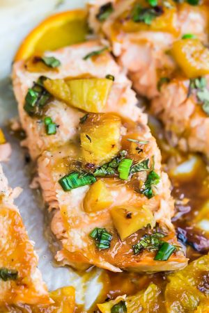 Pineapple Orange Teriyaki Salmon baked in foil or parchment – the perfect easy weeknight dish. Best of all, this healthy recipe takes just 20 minutes to make in just ONE sheet pan so you can totally skip the takeout!