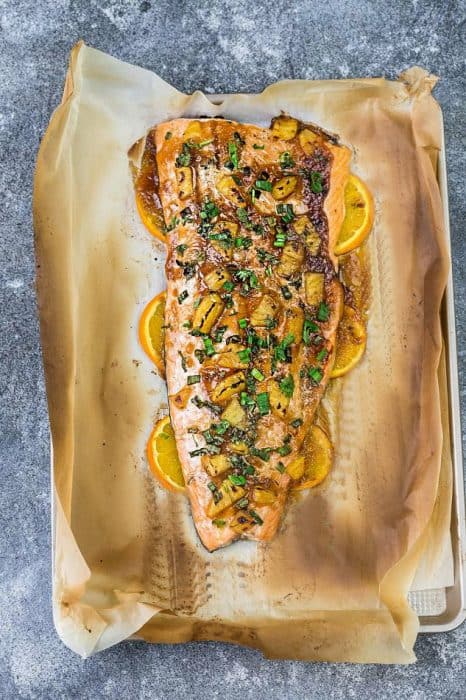 Pineapple Orange Teriyaki Salmon baked in foil or parchment – the perfect easy weeknight dish. Best of all, this healthy recipe takes just 20 minutes to make in just ONE sheet pan so you can totally skip the takeout!