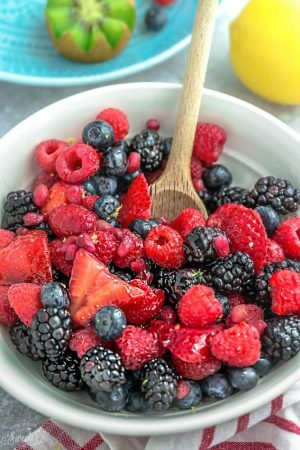 Mixed Berry Fruit Salad – a healthy snack or dessert with a refreshing lemon and honey glaze. Best of all, so easy to customize with your favorite fresh fruit. An easy red, white and blue dish that's perfect to bring along to Memorial Day, Fourth of July potluck, summer barbecue, party or picnic. A delicious snack for kids and adults!