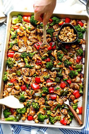 Cashew Chicken Sheet Pan has all the flavors of the popular Chinese restaurant takeout dish made on a sheet pan. Best of all, super easy to make with paleo friendly options. Plus a serving of tender crisp broccoli and red & green bell peppers for a healthier meal. Perfect for busy weeknights! Plus a step-by-step how to video! Weekly Sunday meal prep for the week and leftovers are great for lunch bowls & lunchboxes for work or school.