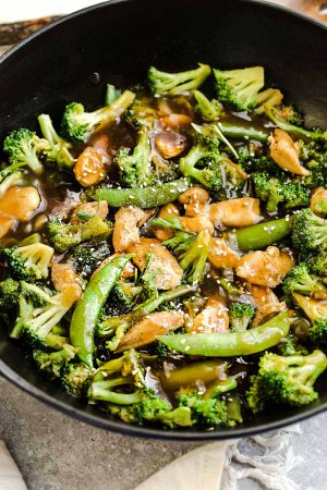 Chicken Stir Fry with Broccoli Snap Peas is the perfect easy weeknight meal. Best of all, comes together in under 30 minutes with your favorite vegetables and sticky and savory Asian sauce. Great for Sunday meal prep for work or school lunchboxes or lunch bowls. Full of flavor and way better than takeout!