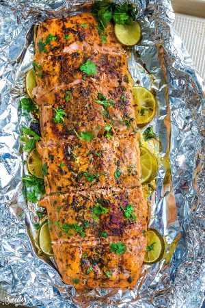 Chili Lime Salmon baked in foil on one sheet pan is fresh, flavorful and super delicious! Best of all, this recipe comes together in less than 30 minutes with tangy lime, chili powder and fresh parsley. The perfect weeknight meal!