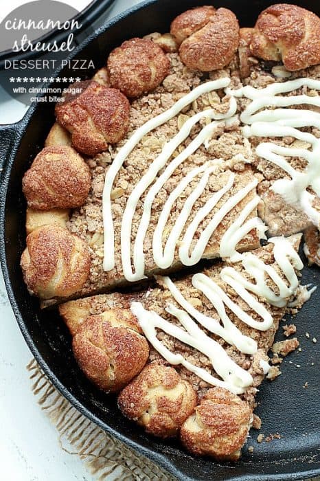 Cinnamon Streusel Dessert Pizza with a Cinnamon Sugar Bites Crust - A cinnamon sugar streusel topping layered over an easy pizza dough with a drizzle of cream cheese frosting. The extra special cinnamon sugar bites crust makes this even more delicious and fun to eat.