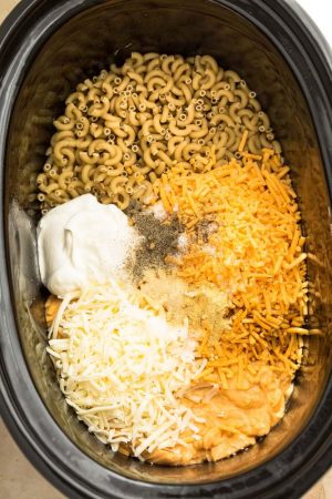 Crock Pot Macaroni and Cheese are the perfect easy and comforting dish for potlucks, parties and game day. Best of all, everything cooks up in the slow cooker - even the pasta so no boiling required! Made with four favorite cheeses for the ultimate creamy mac and cheese!