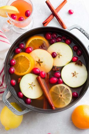 This Easy Homemade Apple Cider Recipe is the perfect easy drink for fall and the holiday season. Best of all, this easy version is made with a blend of juices and infused with apples, orange, lemon, cranberries, cinnamon and cloves. Set and forget and makes your house smell amazing! Warm up with a mug by a cozy fireplace.