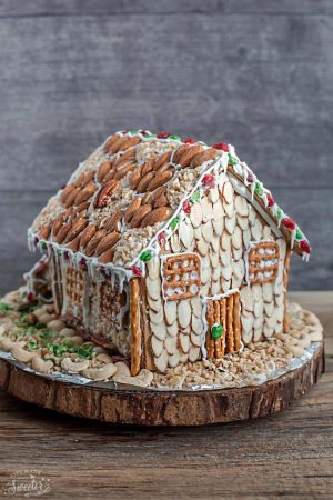 Easy No Bake Gingerbread House - An easy and simple way to make a "gingerbread" house using graham crackers and nuts. It's the perfect holiday activity for the kids and best of all, no baking required!