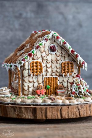 Easy No Bake Gingerbread House - An easy and simple way to make a "gingerbread" house using graham crackers and nuts. It's the perfect holiday activity for the kids and best of all, no baking required!