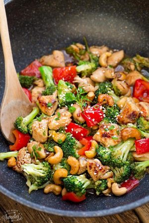 Healthy Cashew Chicken - an easy 20 minute guilt-free gluten free skinny version (plus paleo friendly options) of the popular classic Chinese takeout dish. Plus a serving of tender crisp broccoli and red bell peppers for a healthier meal. Best of all, this recipe comes together in less than 30 minutes in just one pan and perfect for busy weeknights!