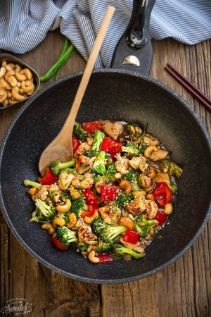 Healthy Cashew Chicken - an easy 20 minute guilt-free gluten free skinny version (plus paleo friendly options) of the popular classic Chinese takeout dish. Plus a serving of tender crisp broccoli and red bell peppers for a healthier meal. Best of all, this recipe comes together in less than 30 minutes in just one pan and perfect for busy weeknights!