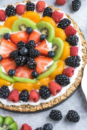 This Healthy Fruit Pizza makes the perfect healthy and extra special breakfast, brunch or dessert. Best of all, it's so easy to make in less than 30 minutes with your favorite fresh fruit, a gluten free granola crust and Vanilla Greek yogurt. Perfect for Mother's Day, Father's Day, Fourth of July, barbecues, potlucks or any other shower or party for spring and summer!