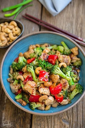 Healthy Cashew Chicken - an easy 20 minute guilt-free gluten free skinny version (plus paleo friendly options) of the popular classic Chinese takeout dish. Plus a serving of tender crisp broccoli and red bell peppers for a healthier meal. Best of all, this recipe comes together in less than 30 minutes in just one pan and perfect for busy weeknights!