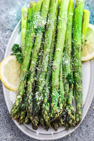 Lemon Parmesan Roasted Asparagus is the perfect quick and easy side dish for holidays or any night of the week. Best of all, this recipe only requires 5 minutes of prep with fresh lemon juice, garlic and Parmesan.