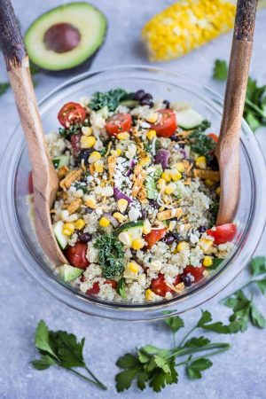 Mexican Quinoa Salad with delicious grilled corn and zucchini make the perfect summery meal. Best of all, it's so easy to customize and is loaded with cucumbers, black beans, cherry tomatoes,, red onions and optional shredded cheese and then tossed in a sweet and tangy honey lime vinaigrette.