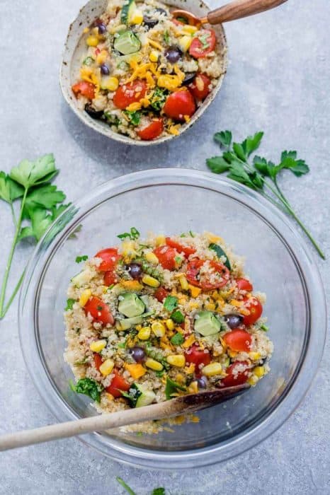 Mexican Quinoa Salad with delicious grilled corn and zucchini make the perfect summery meal. Best of all, it's so easy to customize and is loaded with cucumbers, black beans, cherry tomatoes,, red onions and optional shredded cheese and then tossed in a sweet and tangy honey lime vinaigrette.