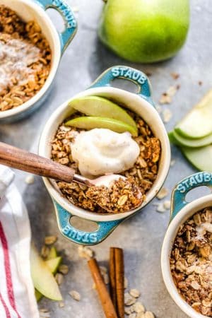 This recipe for Apple Crisp is the perfect easy fall treat. Best of all, these delicious mini crisps take no time at all to prepare and are gluten free, butter free and refined sugar free. Made with fresh apples, and the crispiest oat crumble topping. Serve it bubbling hot with some creamy vanilla frozen yogurt or vanilla ice cream for the ultimate autumn dessert. Make them in a regular pan or the mini size makes them great for potlucks, parties and baby showers!