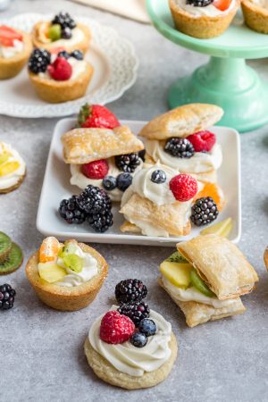 Mini Fruit Pizza - a classic dessert made using homemade soft sugar cookies topped with fresh fruit. Perfect for barbecues, potlucks and parties. Best of all, no dough chilling required and easy to customize!