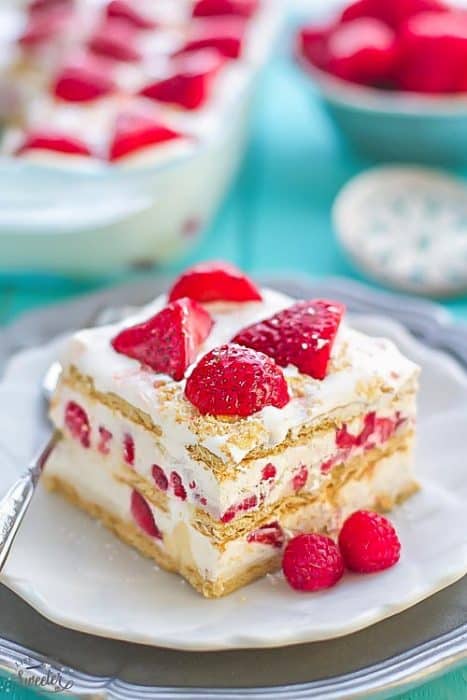 No Bake Strawberry Cheesecake Icebox Cake is the perfect easy dessert for potlucks, barbecues, cookouts, picnics, baby showers, Mother's Day or Fourth of July parties. Best of all, this recipe is great for make-ahead with only 10 minutes of prep time containing fresh whipped cream, cream cheese & graham crackers.
