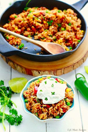 One Pan Mexican Rice Skillet makes the perfect easy 30 minute weeknight meal! Best of all, so simple to customize and everything cooks all in ONE pot - even the rice! Leftovers would be so delicious for school lunchboxes or work lunch bowls and you can even use this recipe for Sunday meal prep!