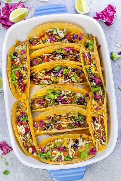 Baked Asian Sesame Chicken Tacos – a simple and delicious recipe perfect for busy weeknights and Cinco de Mayo. Best of all, a short recipe video. Layered with sweet and savory sesame chicken, rainbow vegetables, and a blend of 3 cheeses. Flavor packed and addicting!