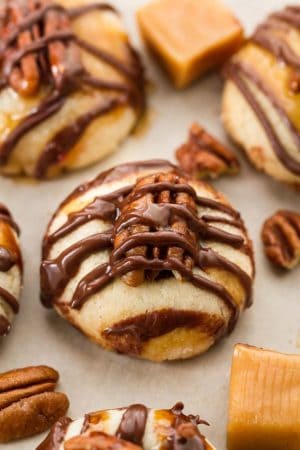 Pecan Turtle Shortbread Thumbprint Cookies make the perfect holiday treat for your Christmas cookie platter. Best of all, they're so easy to make and are full of creamy caramel, chocolate and a crunchy pecan center.
