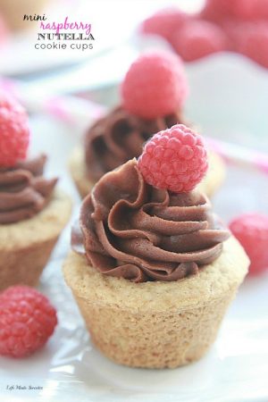 Raspberry Nutella Cookie Cups - A soft & chewy cookie dough base is filled with raspberry jam & topped with a rich Nutella cream cheese frosting.