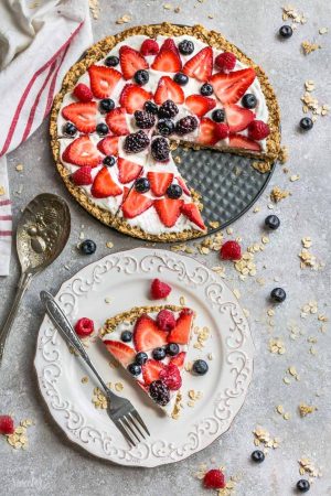 This Healthy Red, White & Blue Fruit Pizza makes the perfect healthy and extra special breakfast, brunch or dessert. Best of all, it's so easy to make in less than 30 minutes with your favorite fresh strawberries, raspberries, blackberries and blueberries, a gluten free granola crust and Vanilla Greek yogurt. Perfect for Memorial Day, Mother's Day, Father's Day, Fourth of July, barbecues, potlucks or any other shower or party for spring and summer!