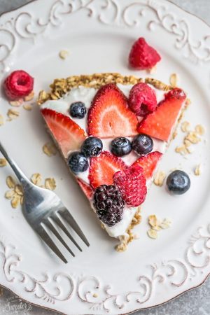 This Healthy Red, White & Blue Fruit Pizza makes the perfect healthy and extra special breakfast, brunch or dessert. Best of all, it's so easy to make in less than 30 minutes with your favorite fresh strawberries, raspberries, blackberries and blueberries, a gluten free granola crust and Vanilla Greek yogurt. Perfect for Memorial Day, Mother's Day, Father's Day, Fourth of July, barbecues, potlucks or any other shower or party for spring and summer!