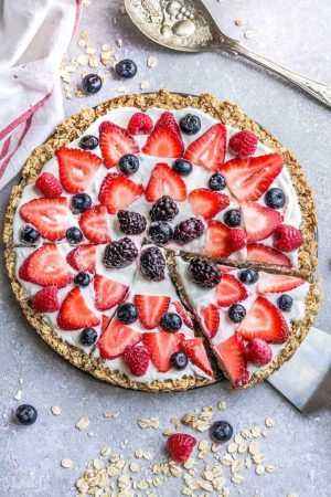This Healthy Red, White & Blue Fruit Pizza makes the perfect healthy and extra special breakfast, brunch or dessert. Best of all, it's so easy to make in less than 30 minutes with your favorite fresh strawberries, raspberries, blackberries and blueberries, a gluten free granola crust and Vanilla Greek yogurt. Perfect for Memorial Day, Mother's Day, Father's Day, Fourth of July, barbecues, potlucks or any other shower or party for spring and summer!