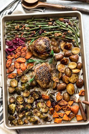 Sheet Pan Turkey Dinner For Two - an easy and healthy one pan Thanksgiving meal for two (or four). Best of all, everything cooks up in under an hour. Includes a juicy turkey, potatoes, green beans, carrots, sweet potatoes and cranberries. 