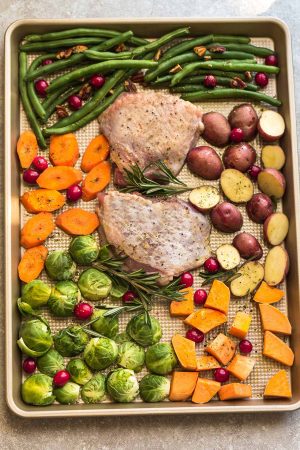 Sheet Pan Turkey Dinner For Two - an easy and healthy one pan Thanksgiving meal for two (or four). Best of all, everything cooks up in under an hour. Includes a juicy turkey, potatoes, green beans, carrots, sweet potatoes and cranberries. 