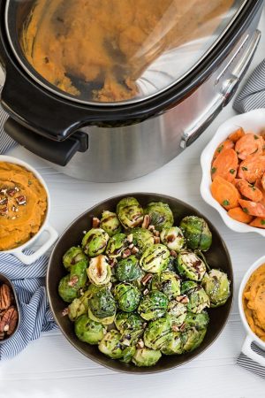 Slow Cooker Balsamic Brussels Sprouts plus 2 other holiday side dishes to help free up your oven. Recipes include Orange Ginger Glazed Carrots and Parmesan Sage Mashed Sweet Potatoes - easy dump and go recipes perfect for the holidays! Best of all, they're made entirely in your crock-pot with no oven or stove time!