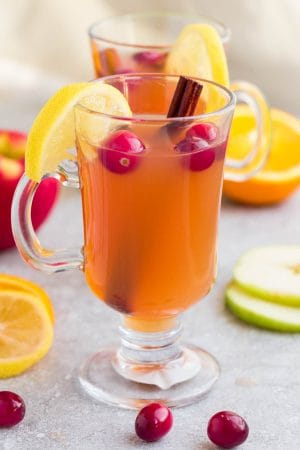 This Homemade Crock Pot (Slow Cooker) Apple Cider Recipe is the perfect easy drink for fall and the holiday season. Best of all, made entirely from scratch in the crock-pot with apples, orange, lemon, cranberries, cinnamon and cloves. Set and forget and makes your house smell amazing! Warm up with a mug by a cozy fireplace.