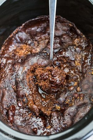 Slow Cooker Hot Fudge Pudding Cake an easy crock-pot dessert perfect for freeing up your oven. With a delicious sauce that forms beneath the cake and best part of all is how easy it is to customize with 4 fun toppings like an ice cream sundae! Plus a step-by-step video!