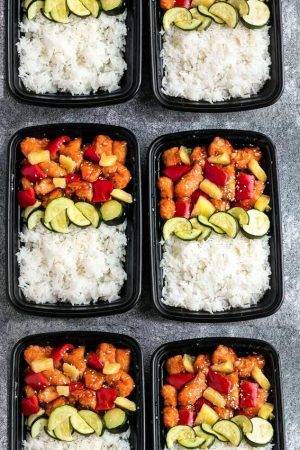 Slow Cooker Sweet and Sour Chicken Meal Prep Lunch Bowls - coated in a sweet, savory and tangy sauce that is even better than your local takeout restaurant! Best of all, it's full of authentic flavors and super easy to make with just 15 minutes of prep time. Skip that takeout menu! This is so much better and healthier! Weekly meal prep for the week and leftovers are great for lunch bowls for work or school.