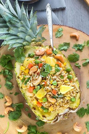 This Pineapple Fried Rice recipe is the perfect easy weeknight side dish to your meal. Best of all, it's easy to customize with any protein like chicken or shrimp and you can add your favorite Thai flavors.. Greta way to clean out your fridge with all those extra vegetables and leftovers also make a great meal to pack for work or school lunch bowls.